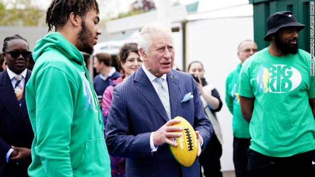 Prince Charles and Camilla pose for a group photo with the cast and crew of “EastEnders,” one of Britain’s longest-running soap operas, at Elstree Studios, just outside London, on March 31.