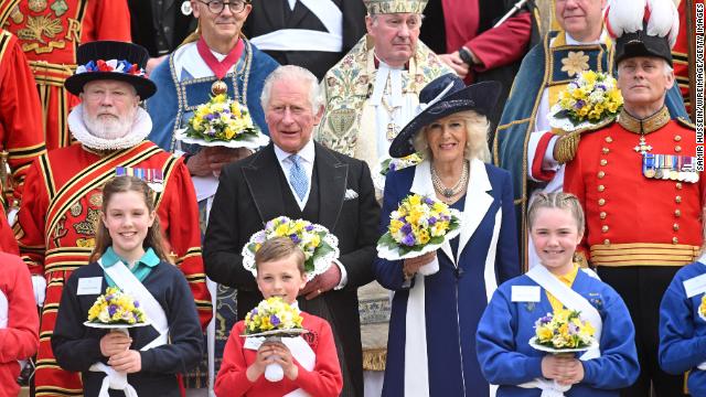 Prince Charles and Camilla pose for a group photo with the cast and crew of “EastEnders,” one of Britain’s longest-running soap operas, at Elstree Studios, just outside London, on March 31.