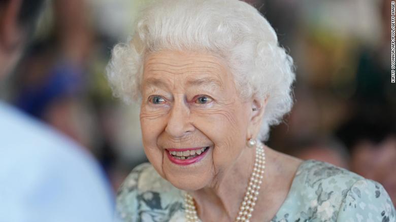 The Queen waves to crowds during the Platinum Jubilee finale, as Charles and Camilla stand nearby. 