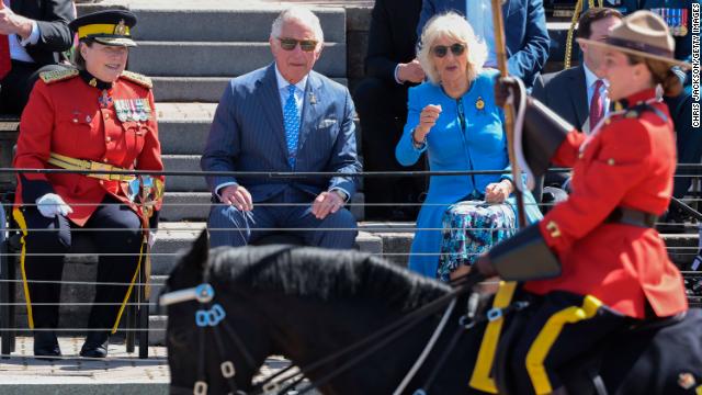 Charles and Camilla watch a parade during their Canada visit.