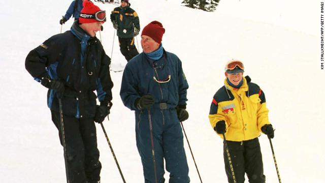 Charles skiing with William and Harry in 1998.