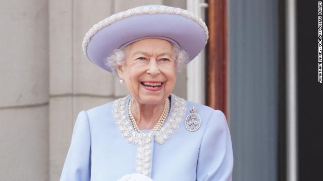 An intricate pearl lace trim and icy blue hue elevated one of Queen Elizabeth's go-to silhouettes: a long formal coat (pinned with a diamond brooch).