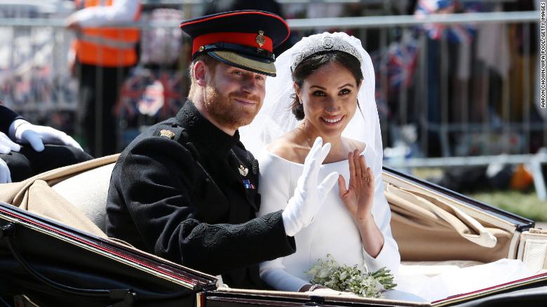 The newlyweds wave during their post-wedding carriage procession in Windsor, England in 2018.  