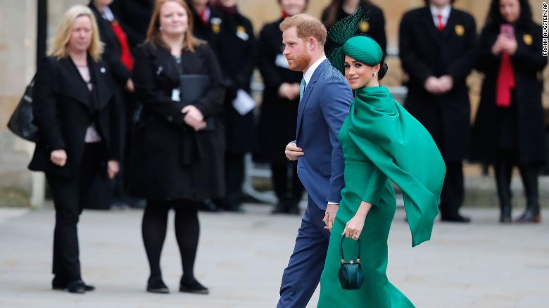 The newlyweds wave during their post-wedding carriage procession in Windsor, England in 2018.  