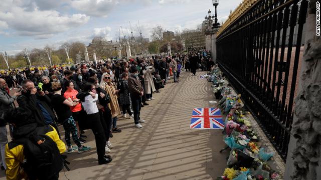 People gather in front of Buckingham Palace in London on Friday.