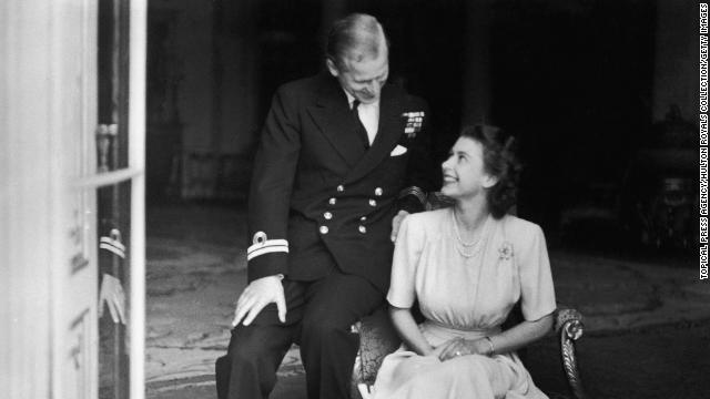 Princess Elizabeth sits with Philip Mountbatten at Buckingham Palace after their engagement was announced, 10th July 1947. 