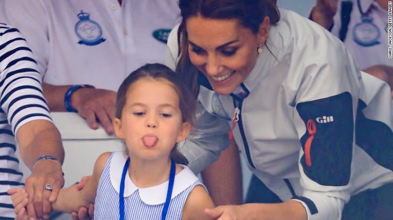 Princess Charlotte playfully sticks out her tongue while attending a King's Cup regatta with her mother, right, in 2019.