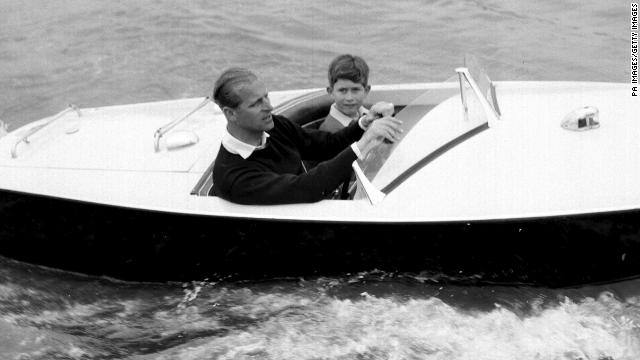 The Prince of Wales with his father, the Duke of Edinburgh during a motorboat race up the river Medina at Cowes, Isle of Wight.