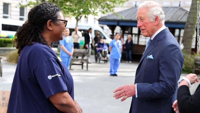 Charles speaks with nursing staff during a visit to St Bartholomew's Hospital.