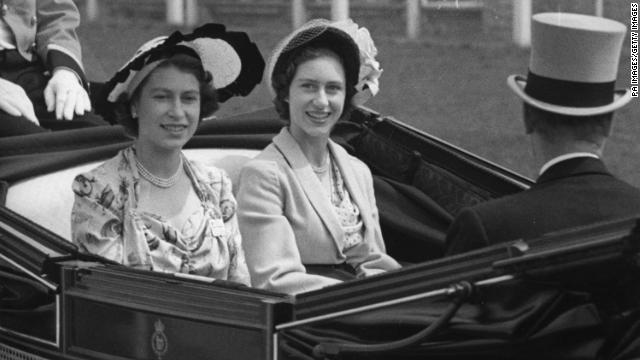 Then-Princess Elizabeth, left, her sister Princess Margaret arrive at the grandstand at Ascot in 1949. 