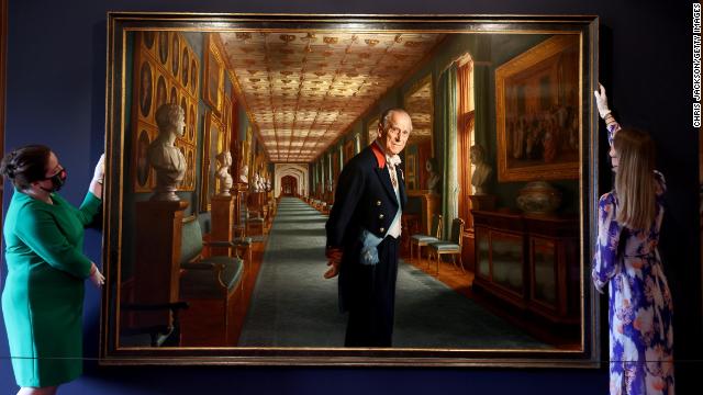 Curators adjust a portrait of Prince Philip by the artist Ralph Heimans in the Great Hall of Windsor Castle.