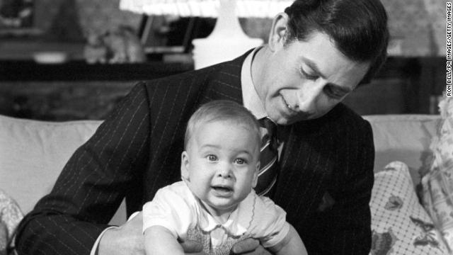 Prince Charles cradles his son Prince William at Kensington Palace, London, in 1982.