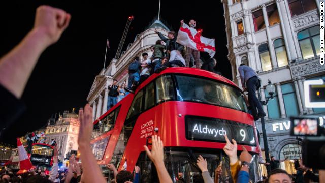 Euphoric England football fans celebrate in the streets of central London after the country reached the finals.