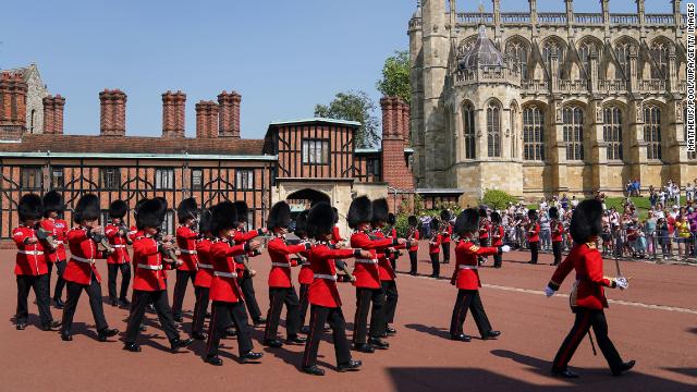 Members of the 1st Battalion Grenadier Guards march out of Windsor Castle in Berkshire after taking part in the Changing of the Guard for the first time since the start of the coronavirus pandemic.