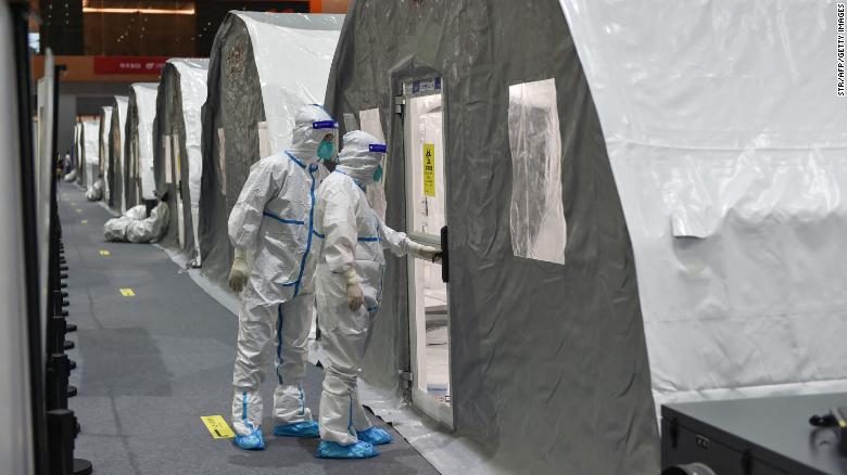 Staff members get to work at a temporary Covid-19 testing facility in Nanjing on July 28