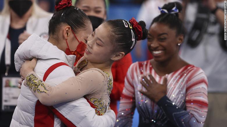 Chinese gymnasts Xijing Tang and Chenchen Guan, and US gymnast Simone Biles celebrate after the women's balance beam final at the Tokyo Olympics on August 3.