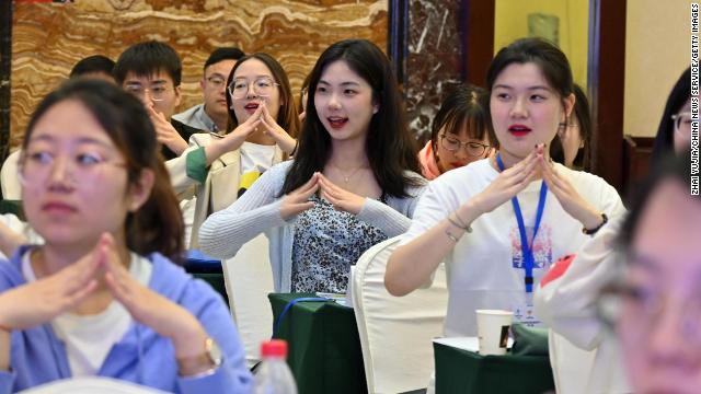 Volunteers for the 2022 Beijing Olympic and Paralympic Games learn sign language during a training session in May.