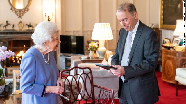 The monarch presents English concert organist Thomas Trotter with the Queen's Medal for Music, during an audience at Windsor Castle.