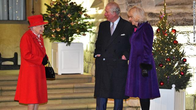 The Queen, Prince Charles and Camilla talk as they wait to thank key workers for the work they are doing during the coronavirus pandemic and over Christmas in the quadrangle of Windsor Castle on December 8, 2020.