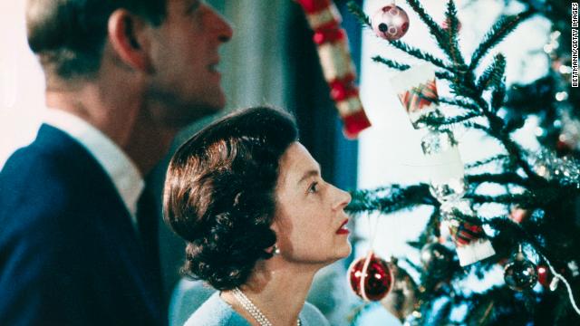 Queen Elizabeth II and Prince Philip put finishing touches to their Christmas tree at Windsor Castle in a still from a documentary in 1969. 