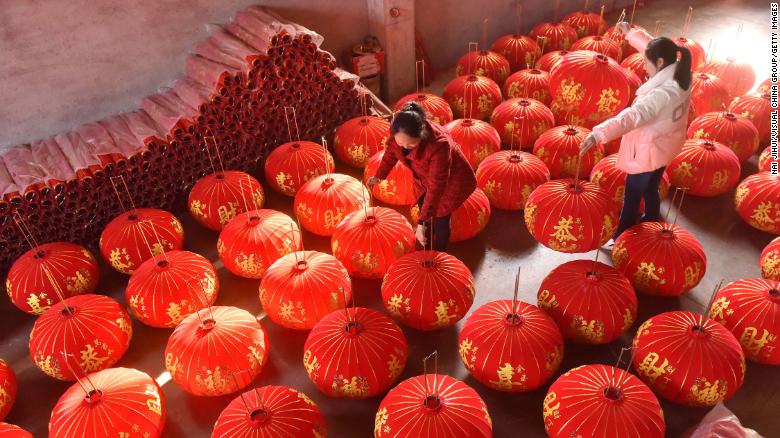 Workers dry off red lanterns at a workshop in preparation for the upcoming Lunar new year in Shuangfeng County on December 19, 2021 in Loudi, Hunan province of China.