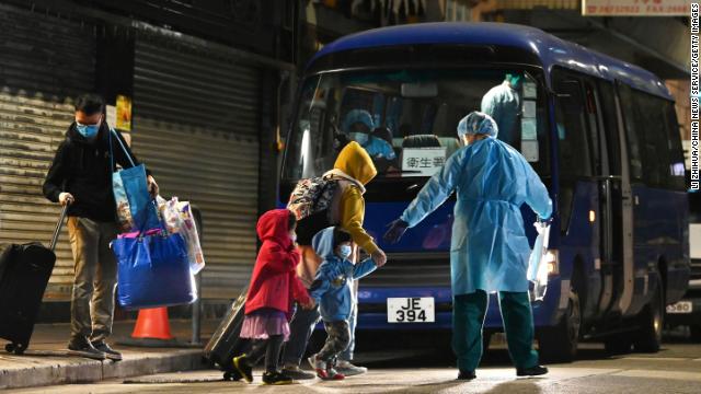 A worker brings residents to quarantine after new Covid-19 cases were reported on January 9 in Hong Kong.