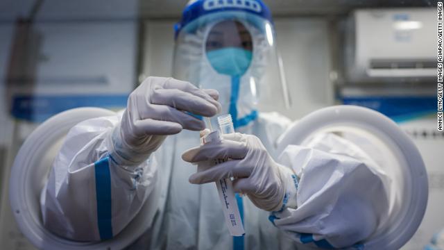 Medical staff prepare to collect mandatory daily Covid-19 tests from members of the media at the Beijing Olympics on February 4.