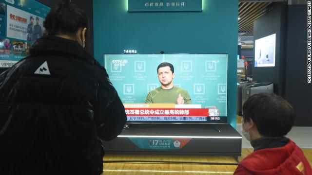 People watch a television news report on the Russian invasion into Ukraine at an appliance store in Hangzhou, China, on February 25.