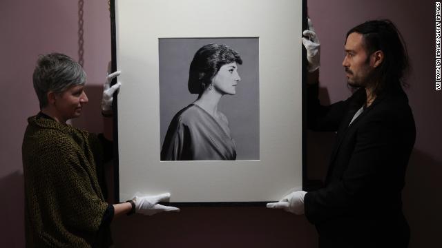 Conservators handle the Bailey portrait of Diana.