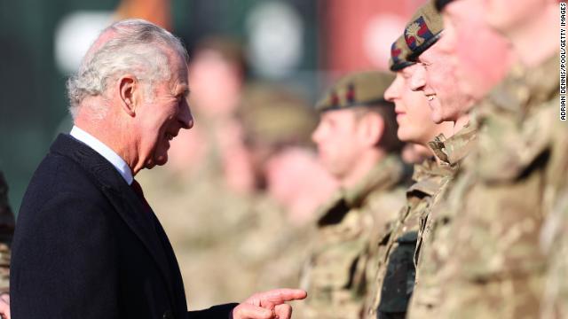 Prince Charles chats with a soldier from the Prince of Wales Company while visiting the Combermere Barracks in Windsor on Tuesday. 