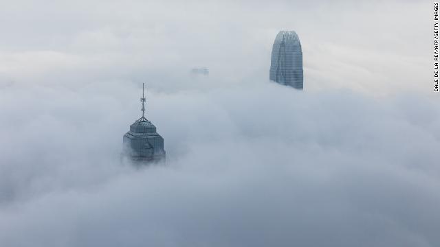 Two skyscrapers in Hong Kong peeking through a thick layer of fog on March 22.