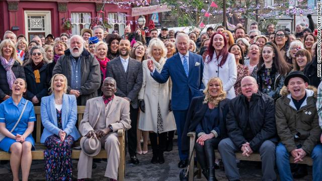 Prince Charles and Camilla pose for a group photo with the cast and crew of “EastEnders,” one of Britain’s longest-running soap operas, at Elstree Studios, just outside London, on March 31.