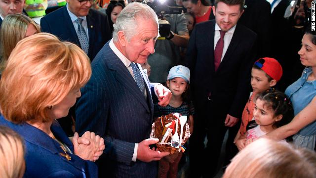 Britain's Prince Charles and Princess Margaret, the Custodian of the Romanian Crown, offer presents to Ukrainian refugees during a visit at a donation center in Bucharest, Romania on Wednesday.