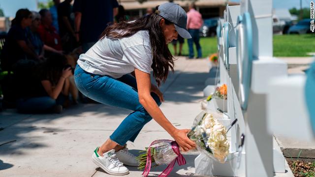 Meghan, Duchess of Sussex, leaves flowers at the memorial site.