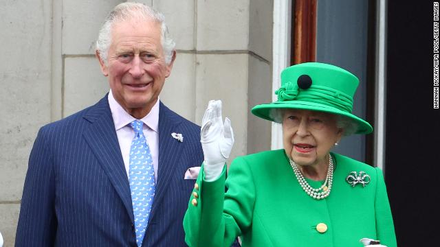 Prince Charles stands next to the Queen as she waves to crowds on the final day of her Platinum Jubilee celebrations on Sunday. 