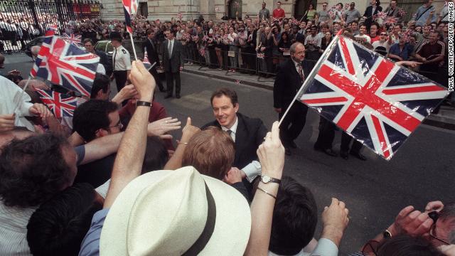 Tony Blair greets Labour supporters outside 10 Downing Street after a historic landslide election in May 1997. 