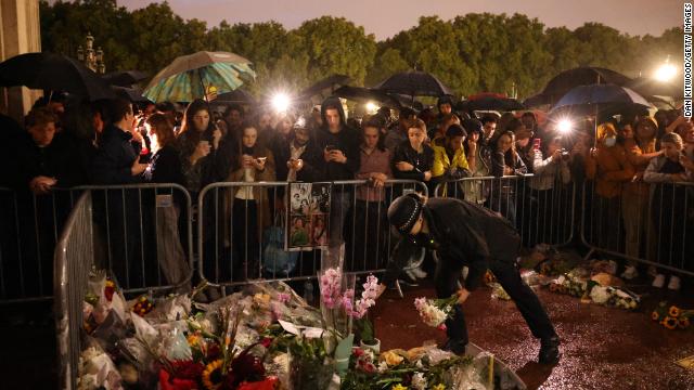 Mourners leave floral tributes outside Buckingham Palace.