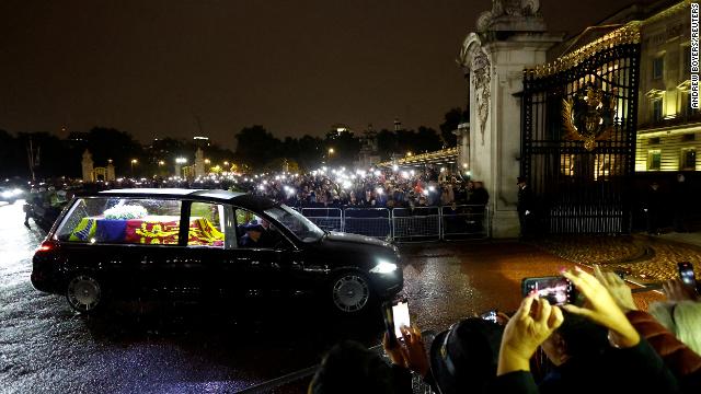 The hearse carrying the Queen's coffin arrives at the Buckingham Palace on Tuesday evening. 