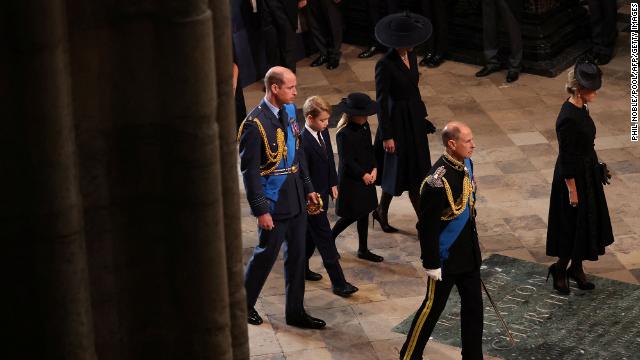 Members of the royal family walk behind the late monarch's coffin.