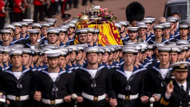 The coffin of Queen Elizabeth II is escorted by Royal Navy sailors as it travels from Westminster Abbey to Wellington Arch after the monarch's funeral in London on Monday, September 19. 