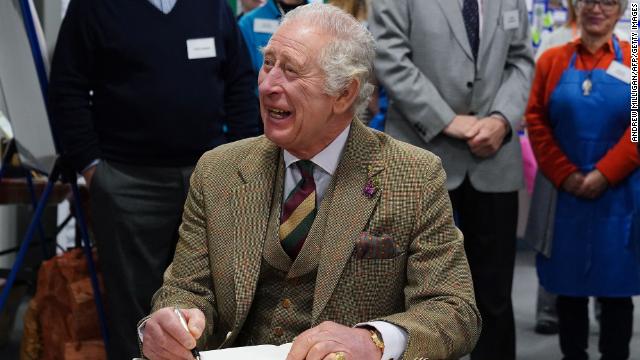 Britain's King Charles III signs a guestbook during a visit to the Aboyne and Mid Deeside Community Shed in Aboyne, Aberdeenshire on January 12.