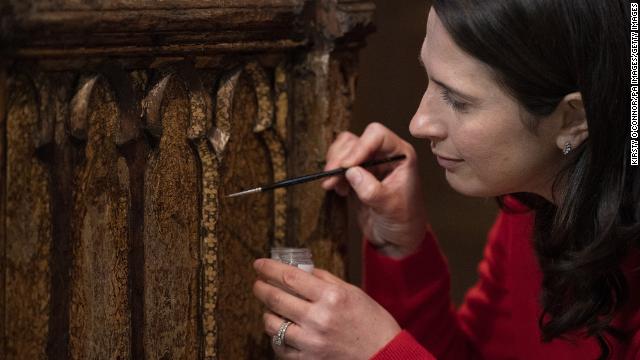 Conservator Krista Blessley works on the Coronation Chair at Westminster Abbey.