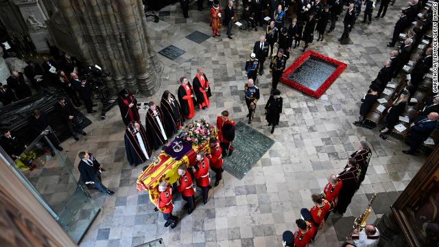 The coffin carrying Queen Elizabeth II with the Imperial State Crown resting on top of it departs Westminster Abbey during the late monarch's state funeral on September 19, 2022 in London.