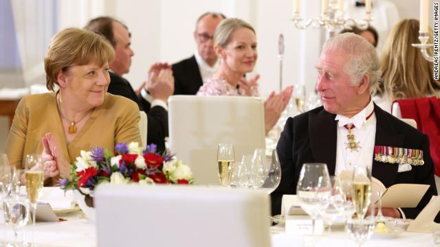 Former German Chancellor Angela Merkel, left, and the King attend the state banquet on Wednesday.