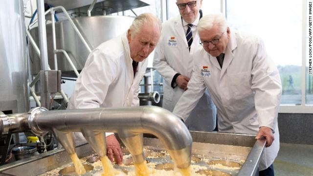 The King and Steinmeier try cheese-making during a visit to Brodowin, Germany, on Thursday.