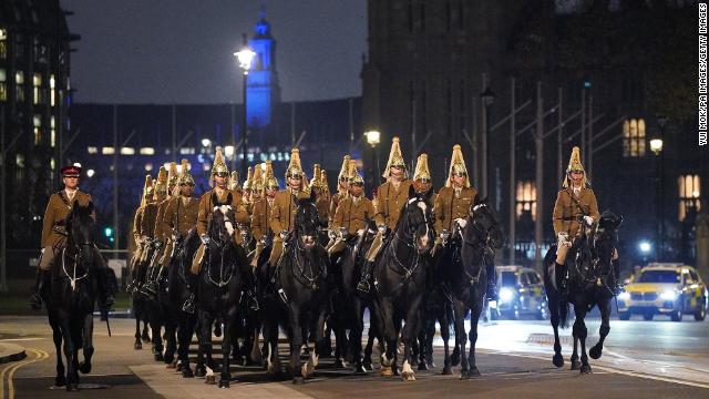 Members of the military outside Westminster Abbey during a night time rehearsal for the coronation.