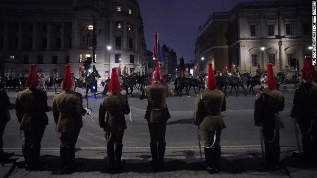 Members of the military ride along Whitehall in central London. 