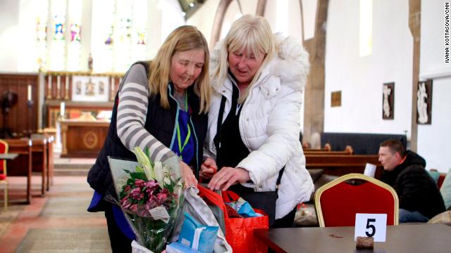 Liz Coopey, left, a volunteer at the Given Freely Freely Given food bank in Doncaster, helps local resident Angela Davis with her shopping bags.