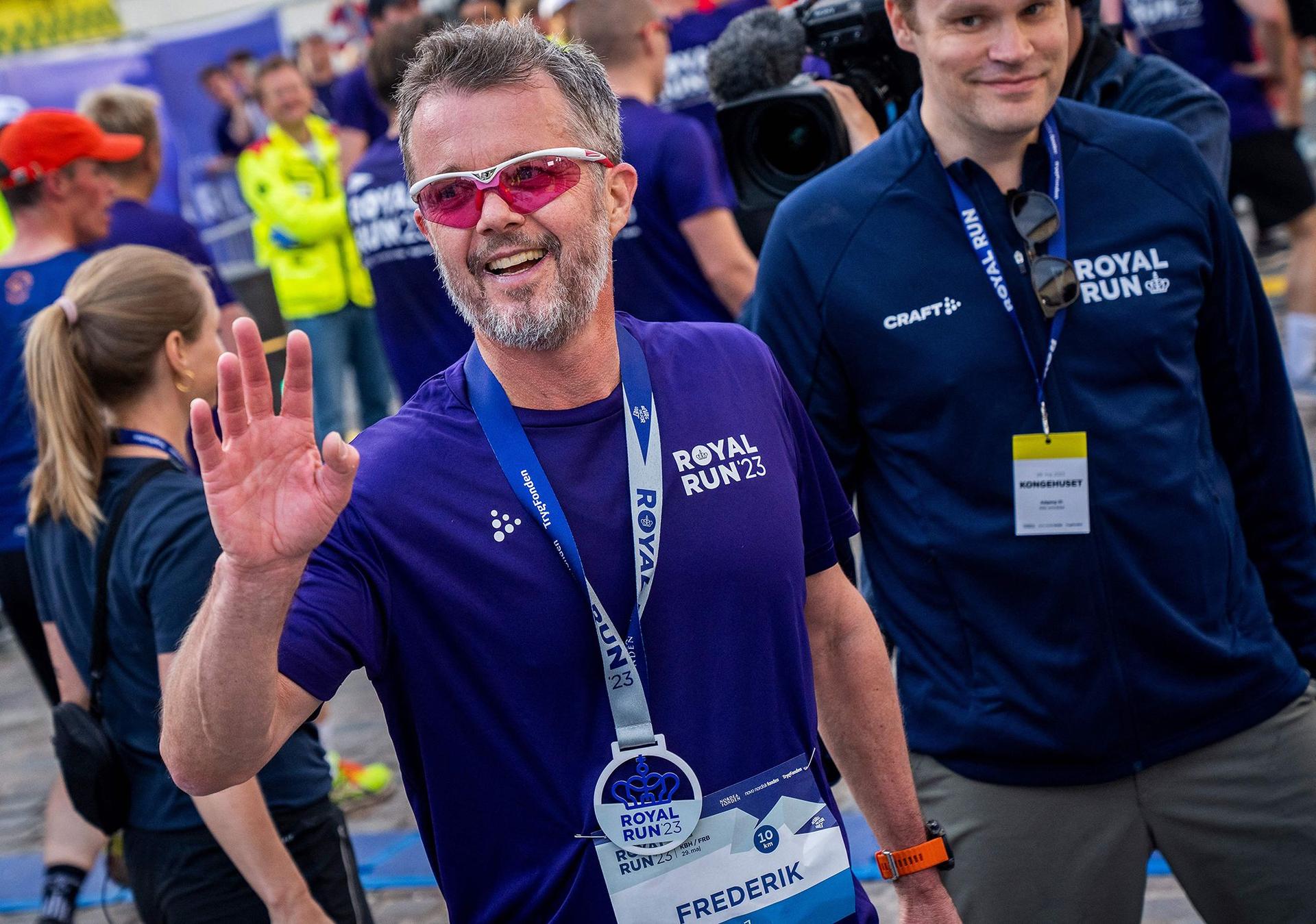 The avid sportsman waves after crossing the finish line during the yearly Royal Run in Copenhagen last May.