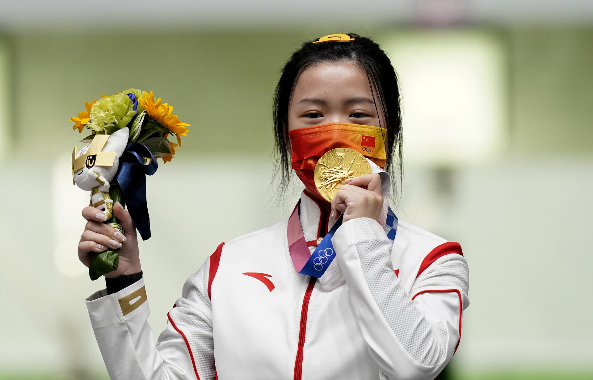 China's Yang Qian celebrates with her gold medal after winning the women's 10m air rifle on Saturday, July 24.